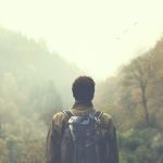 hiker walking in a mystic forest